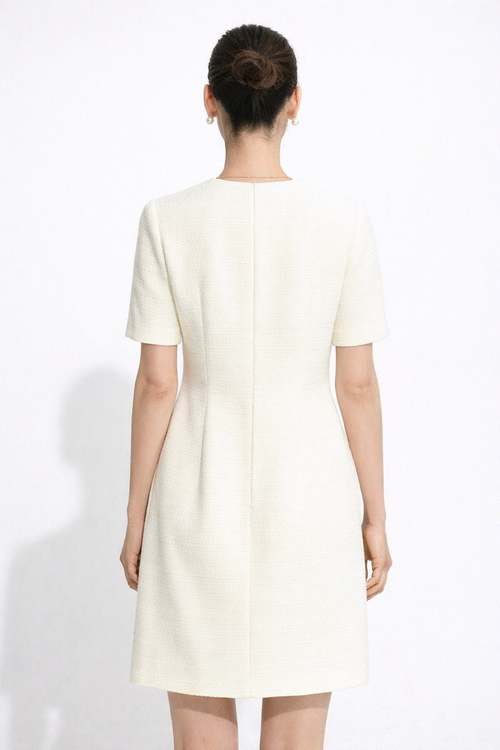 Woman wearing a white dress against a white background