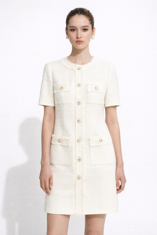 Woman wearing a white  ella dress by wisteria with gold buttons on a white background