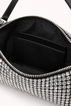 Close-up of a black handbag with silver embellishments on a white background