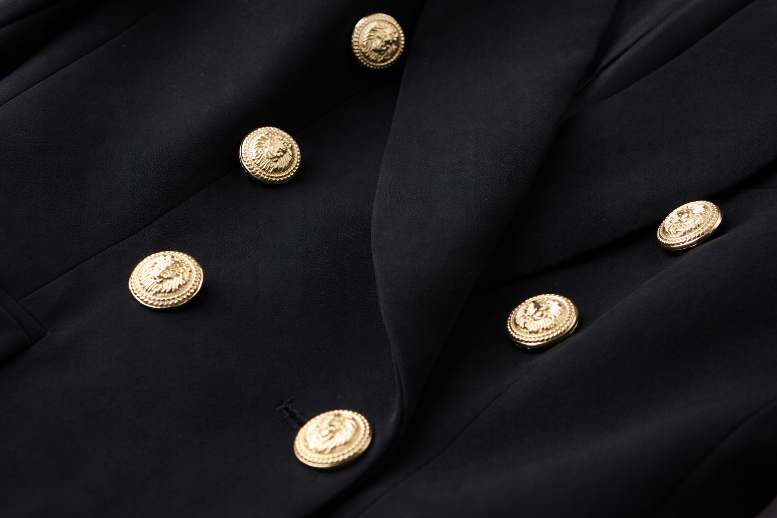 Close-up of a black chloe blazer coat with gold buttons luxury style